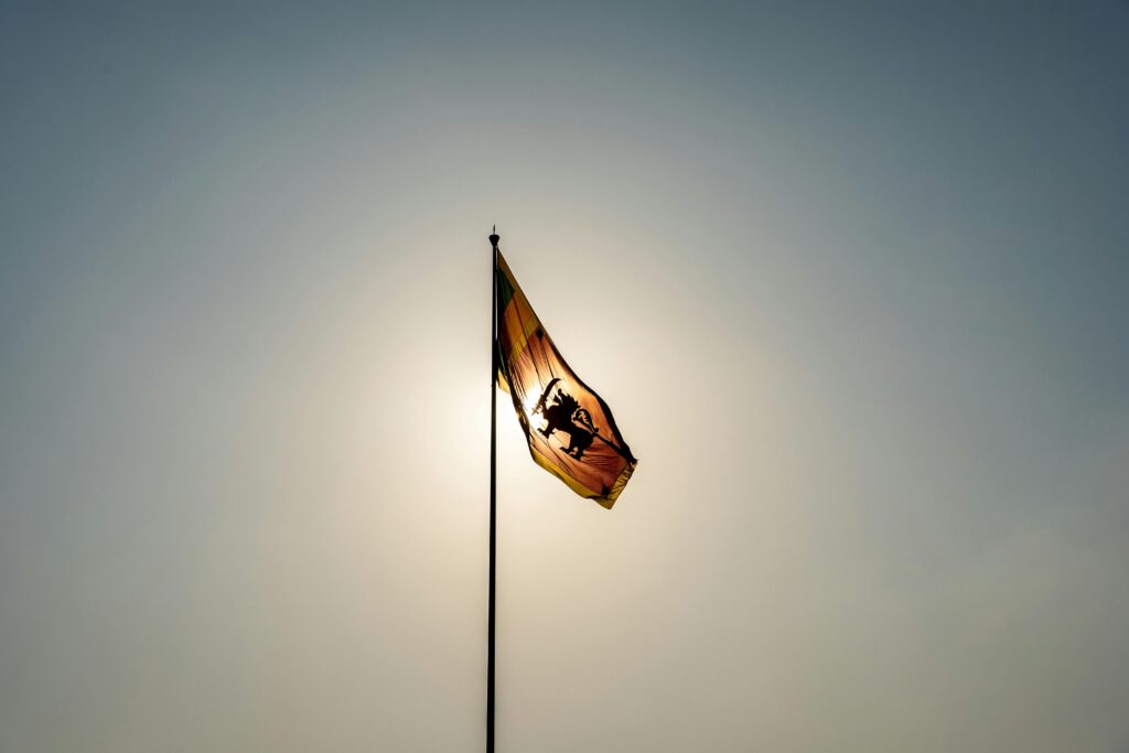 Sri Lankan flag waving against a clear sky in Colombo, symbolizing national pride.